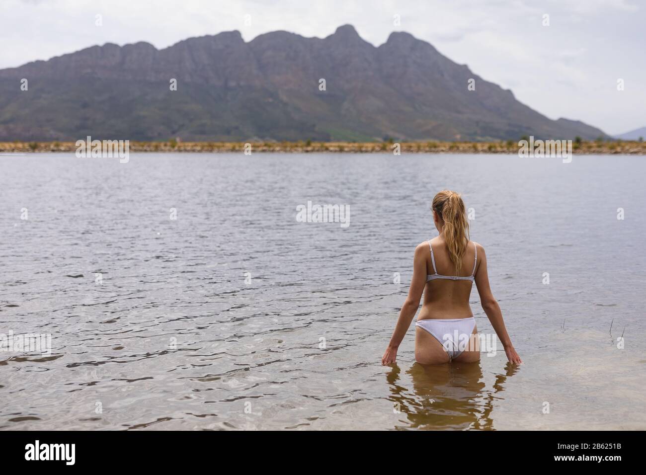 Caucasian woman ready to swim in the lake Stock Photo