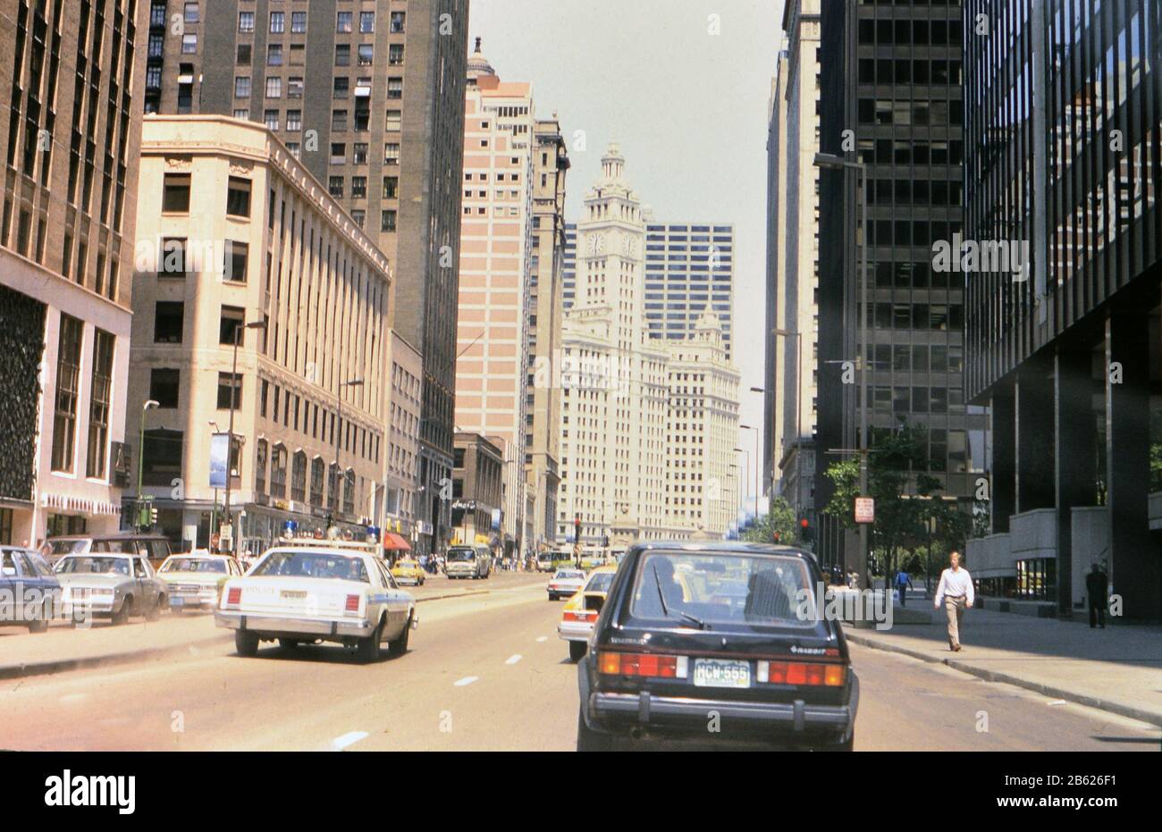 Traffic in downtown Chicago heading towards the Wrigley Building (a Volkswagen Rabbit and a Chicago Police car identified) ca. 1985 Stock Photo
