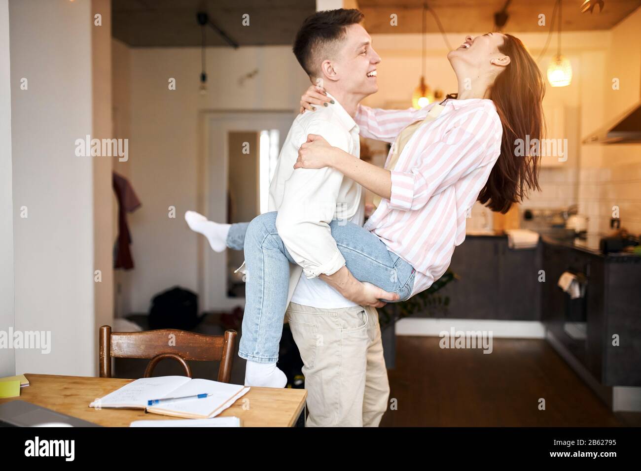 funny cheerful young people laughing, enjoying free time, close up side view photo. great time with family. happiness, positive feeling and emotion Stock Photo
