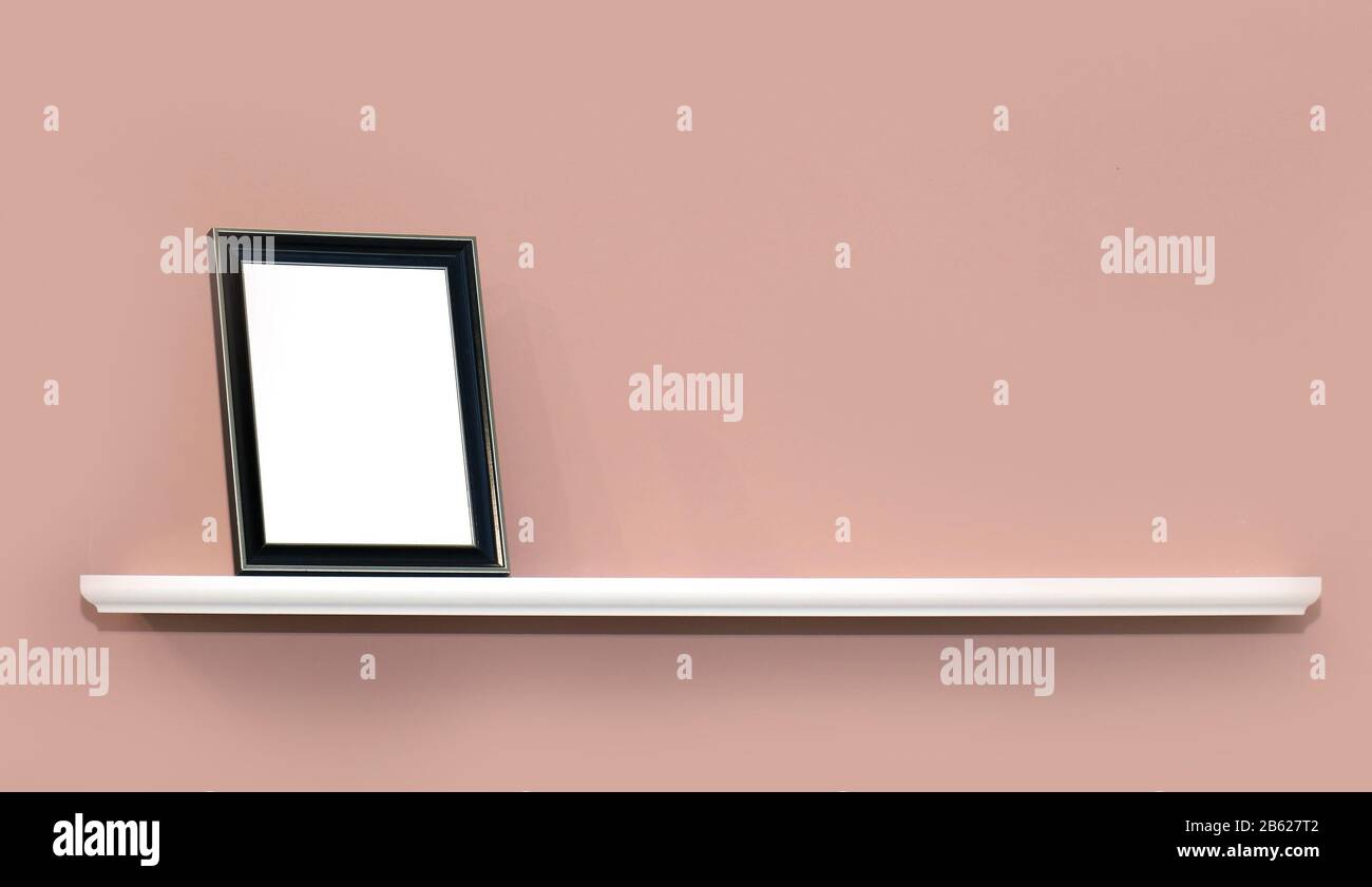 Empty modern metal frame on wooden wall shelf Stock Photo - Alamy