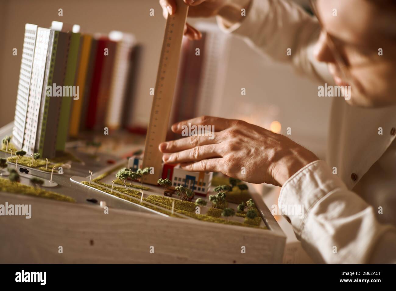 professional architect using engineering tools on model building, close up cropped photo Stock Photo