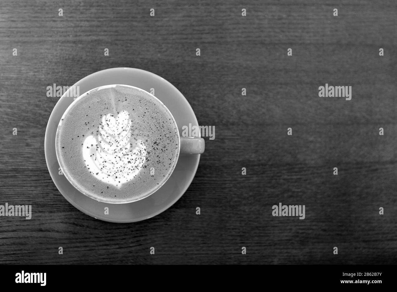 Black and white. Big Coffee cup with milk on the wooden table. cappuccino or latte drink, cup of coffee on table flat lay view. Cup of cafe au lait Stock Photo