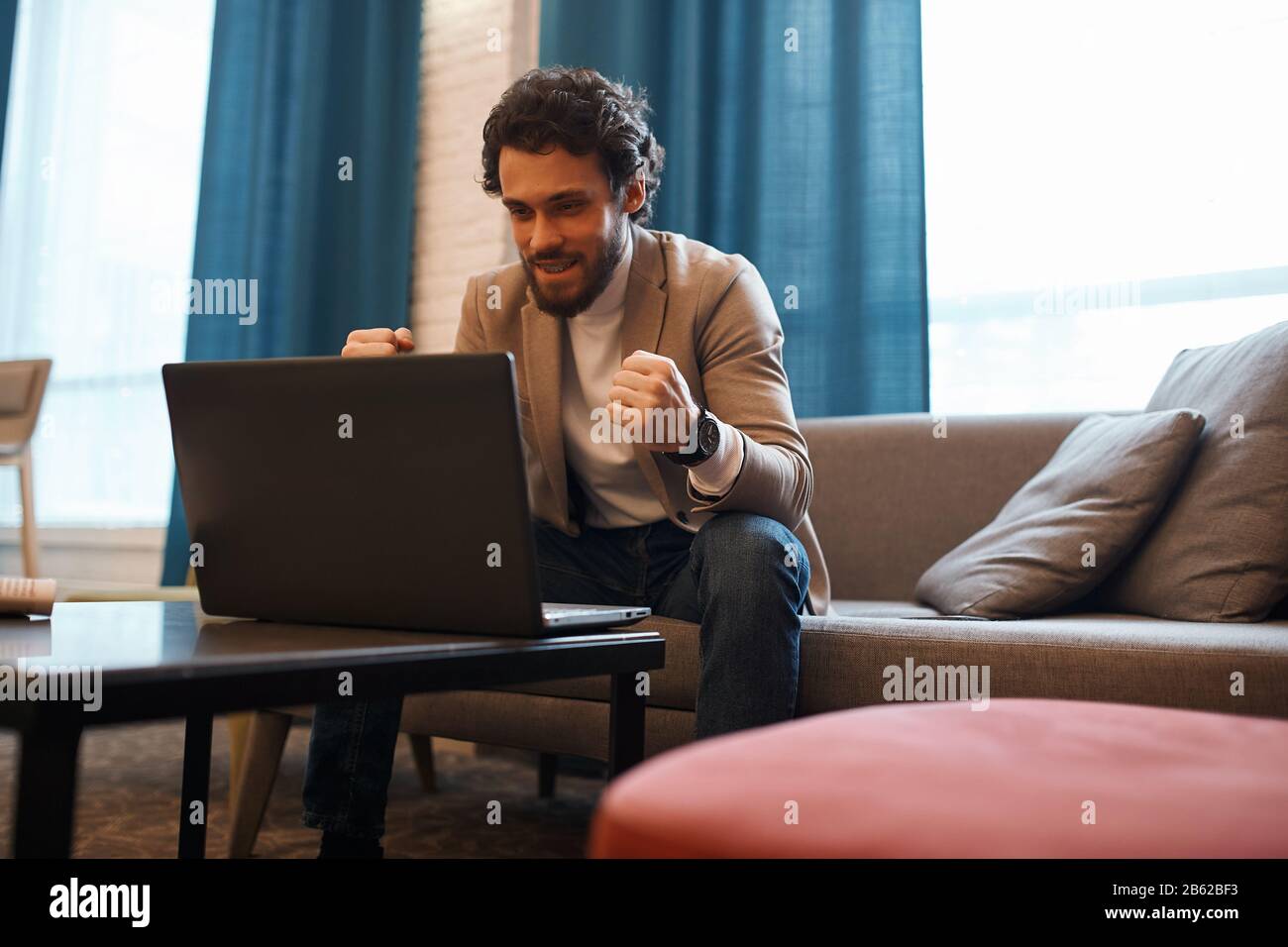 cheerful man is celebrating winning of his favourite team, close up photo. positive feeling and emotion. celebration, Stock Photo
