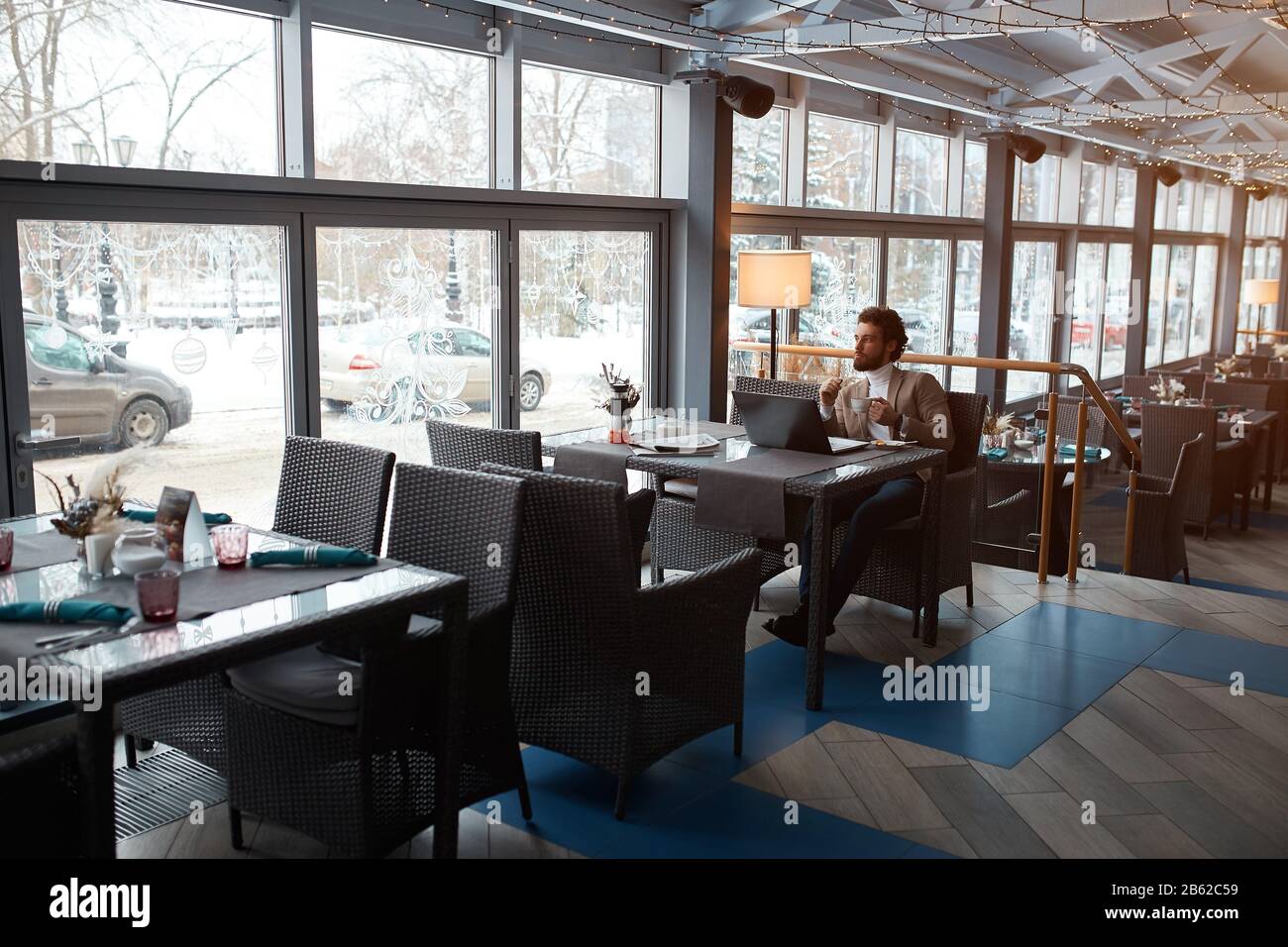 young elegant man enjoying peace and quiet, man having breakfast after difficult working day. Stock Photo