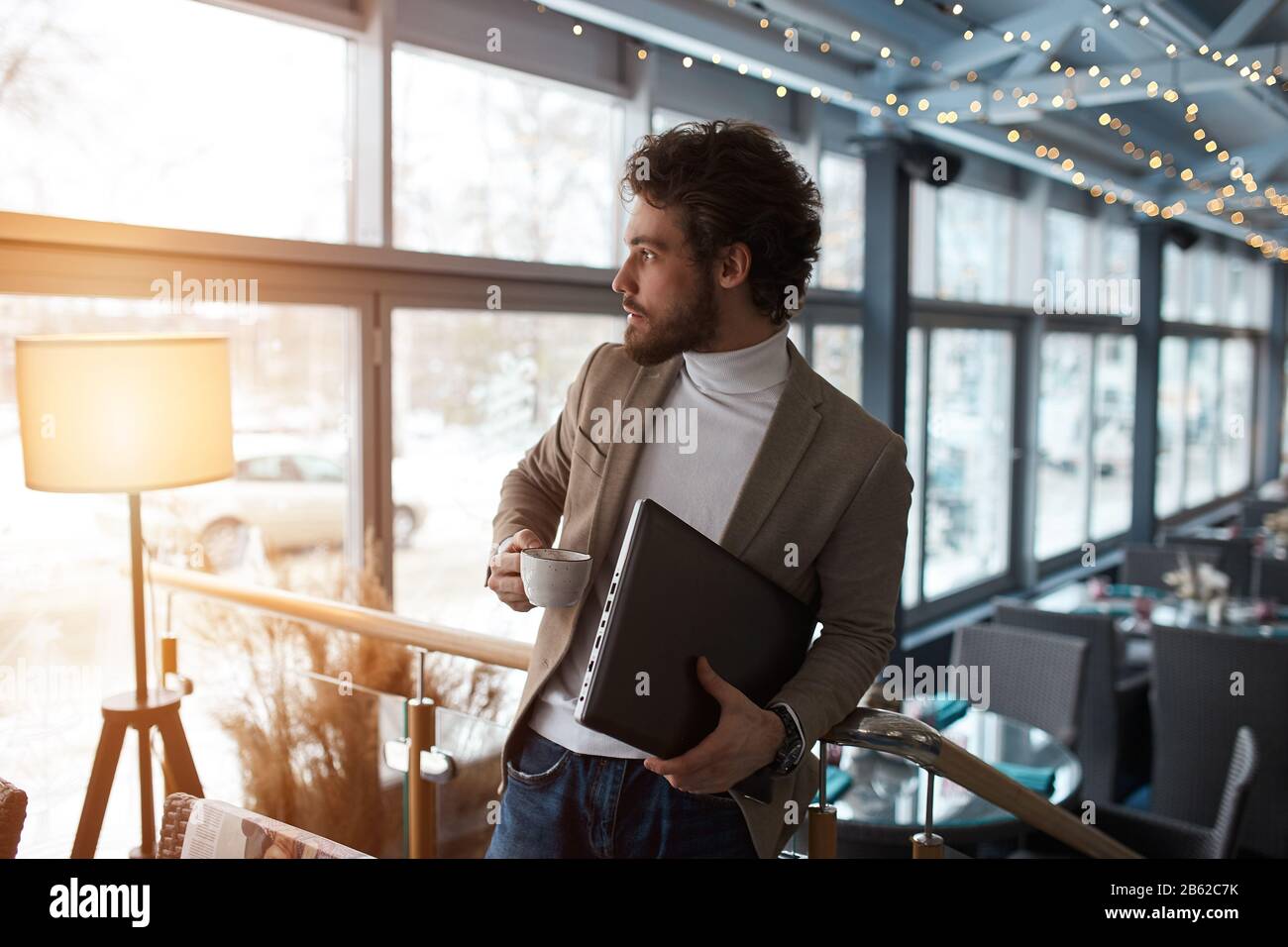 young businessman having breakfast in the cafe, close up side view photo Stock Photo