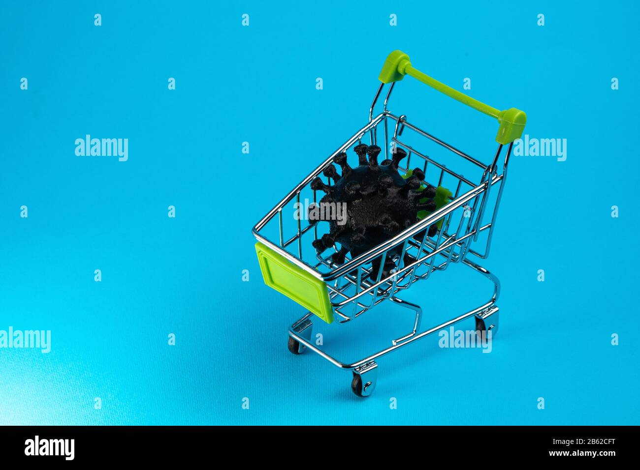 Coronavirus in a shopping cart. Propagation concept COVID-19. Copy space Stock Photo