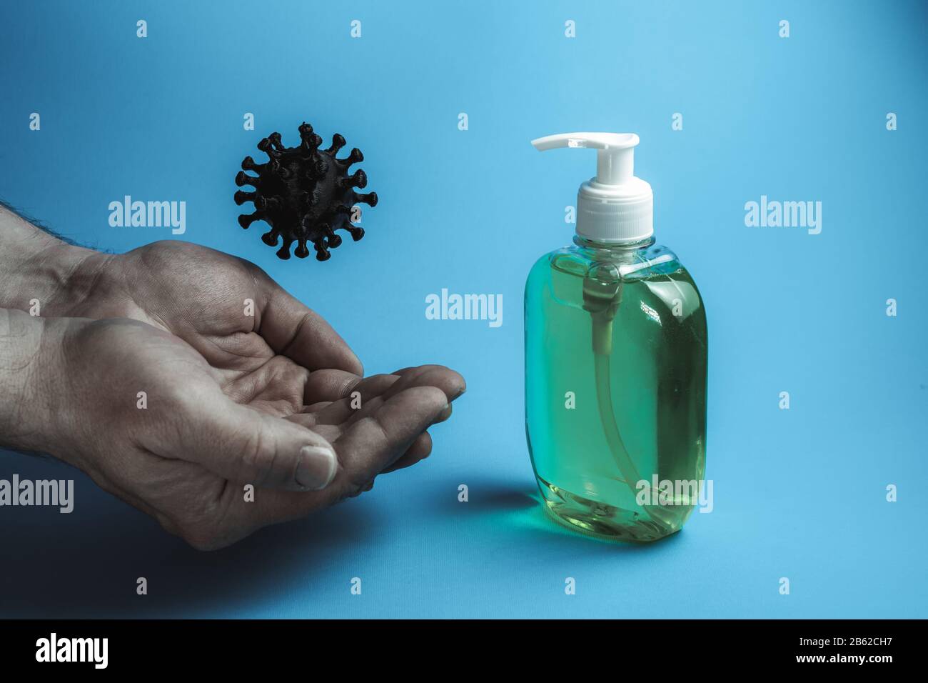 Male dirty hands, coronavirus and liquid soap on a blue background