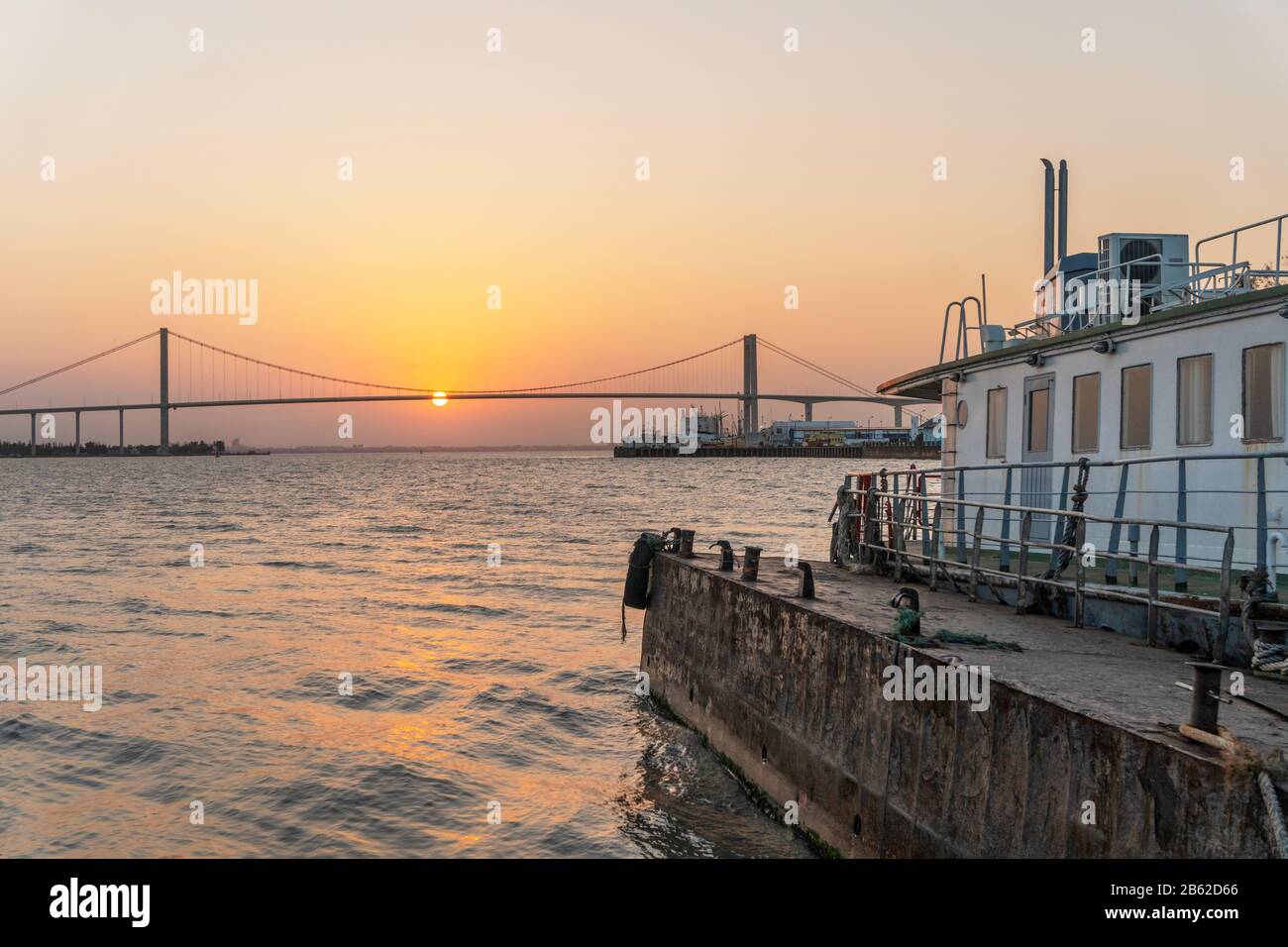 Sun hanging on The Golden Bridge in Maputo, Mozambique Stock Photo