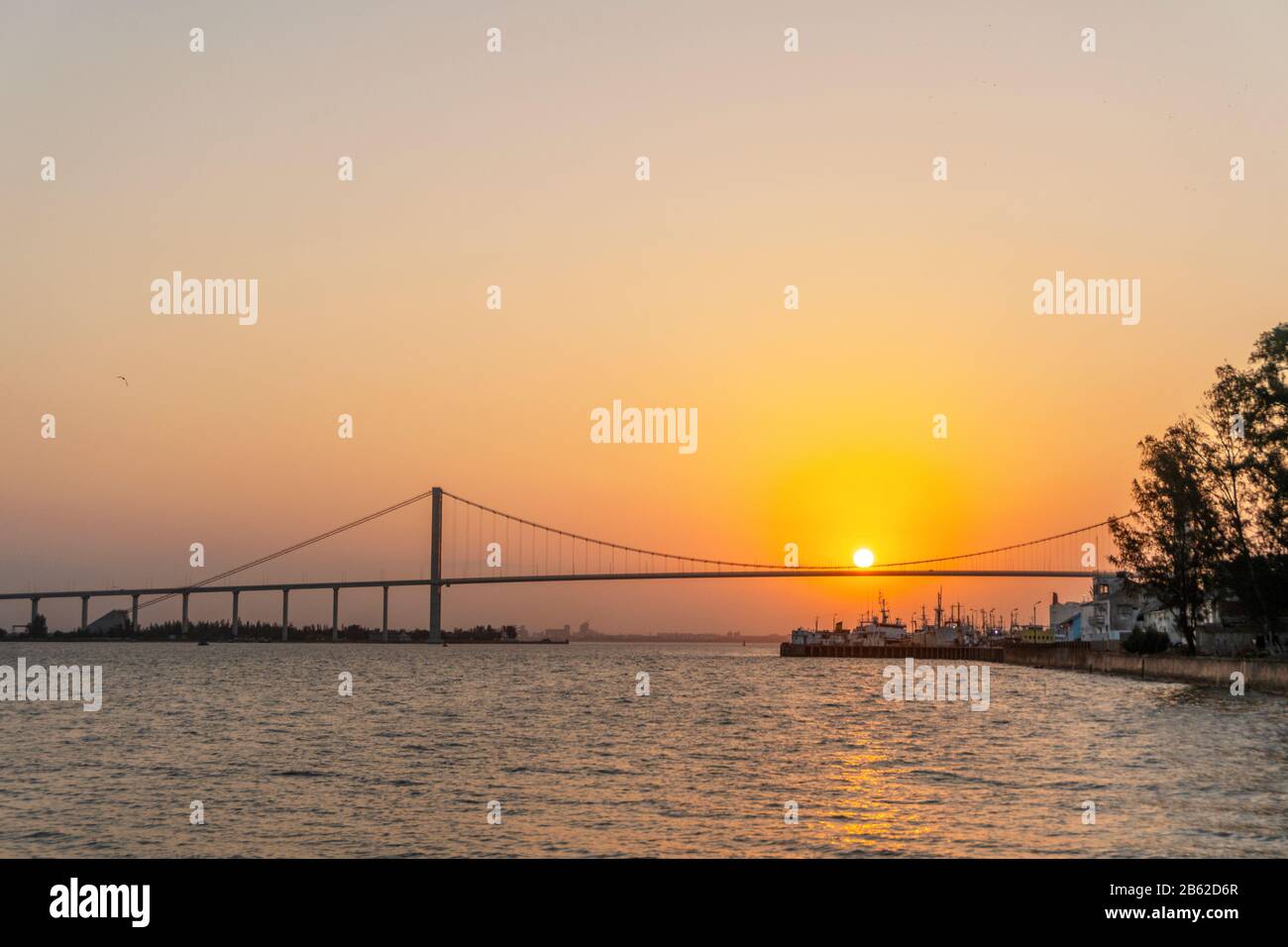 Sun hanging on The Golden Bridge in Maputo, Mozambique Stock Photo