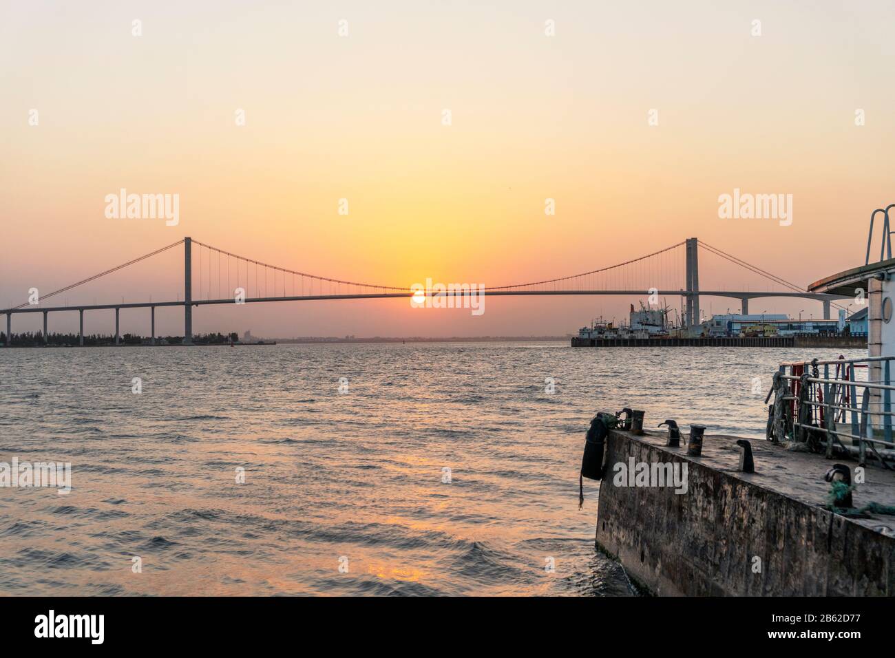 Sun hanging on The Golden Bridge in Maputo, Mozambique Stock Photo