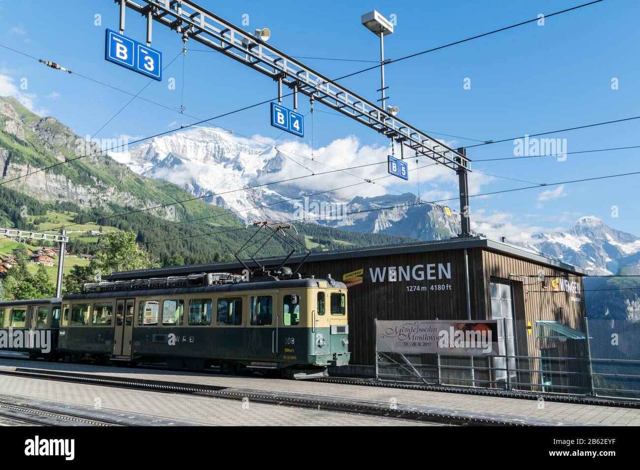 Wengen train station with wagon with mountain in the backdrop Stock Photo