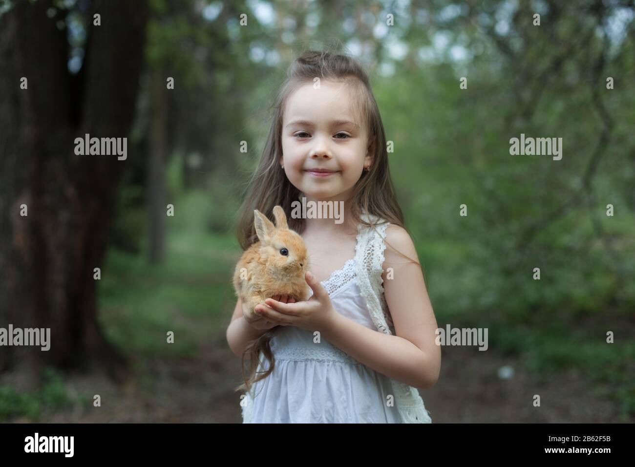 Girl holding a rabbit hi-res stock photography and images - Alamy