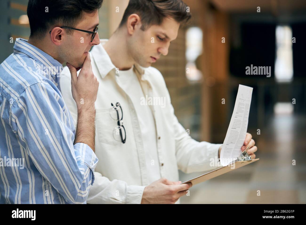 Portrait of two clever businessmen brainstorming in the office. close up side view photo. job, profession, occupation Stock Photo