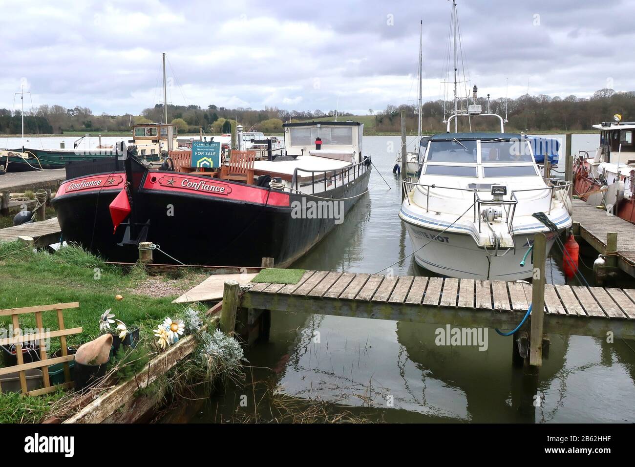 Woodbridge, Suffolk, UK - 9 March 2020: Houseboat for sale seen on a wet and windy afternoon walk alongside the River Deben from Woodbridge to Melton. Stock Photo