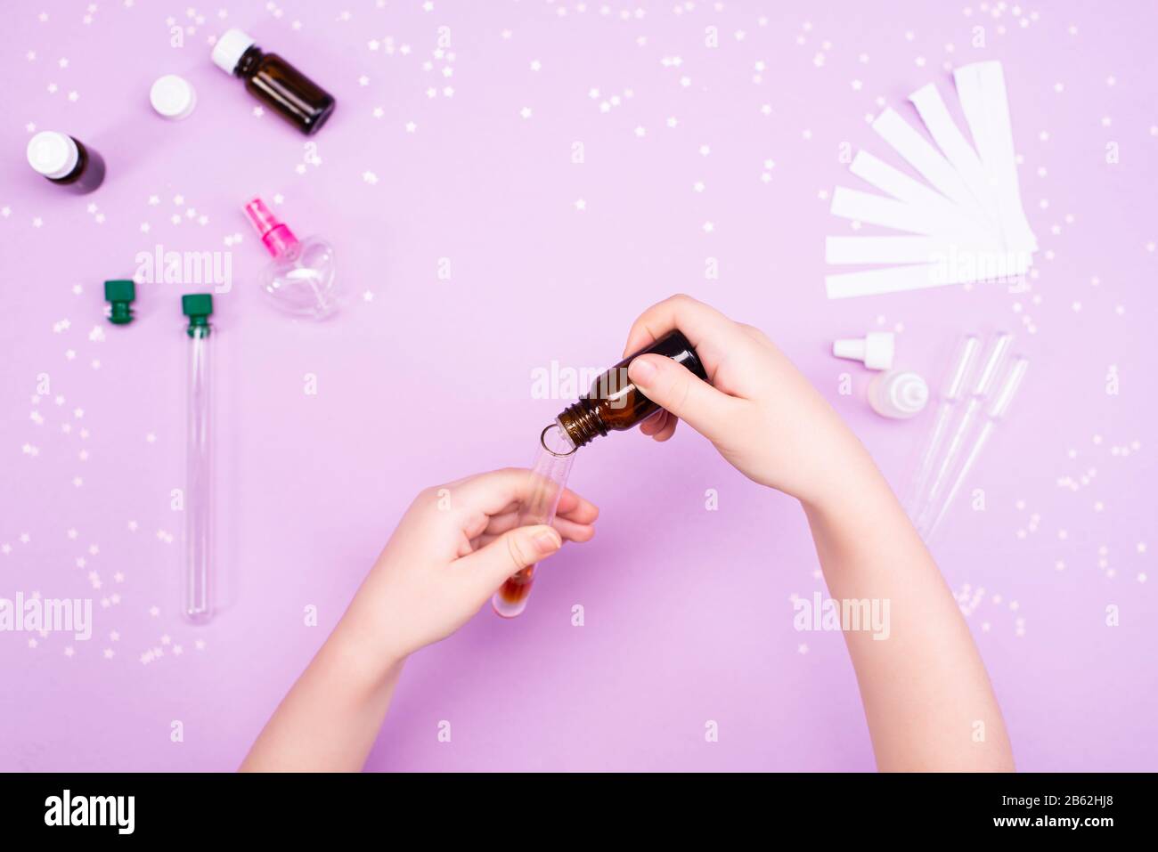 Making perfumes at home. Children's art project. Children's hands make