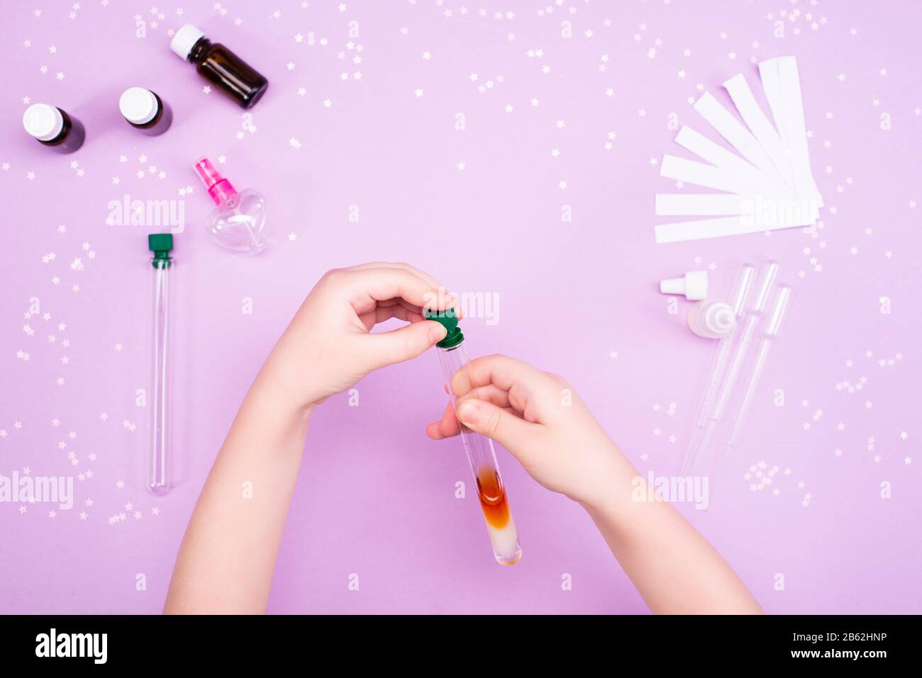 Making perfumes at home. Children's art project. Children's hands make