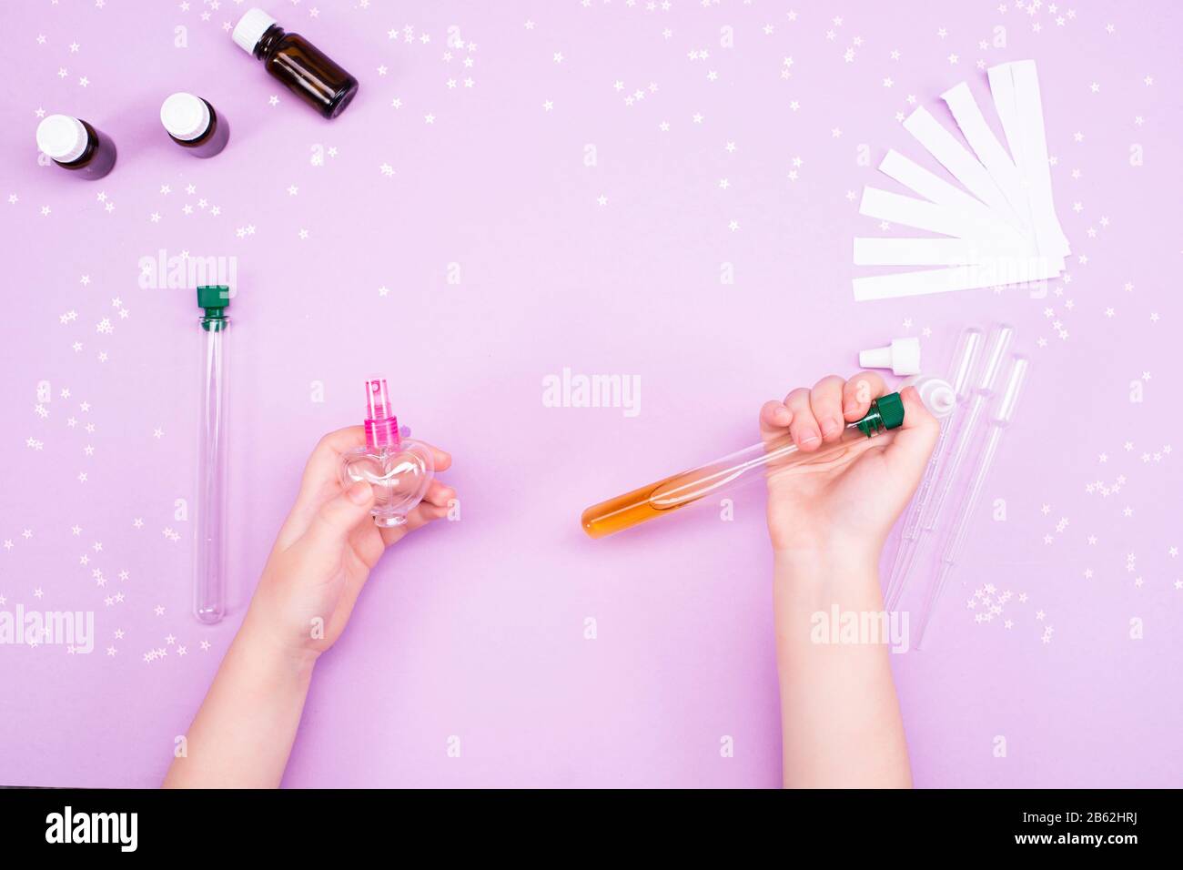 Making perfumes at home. Children's art project. Children's hands make