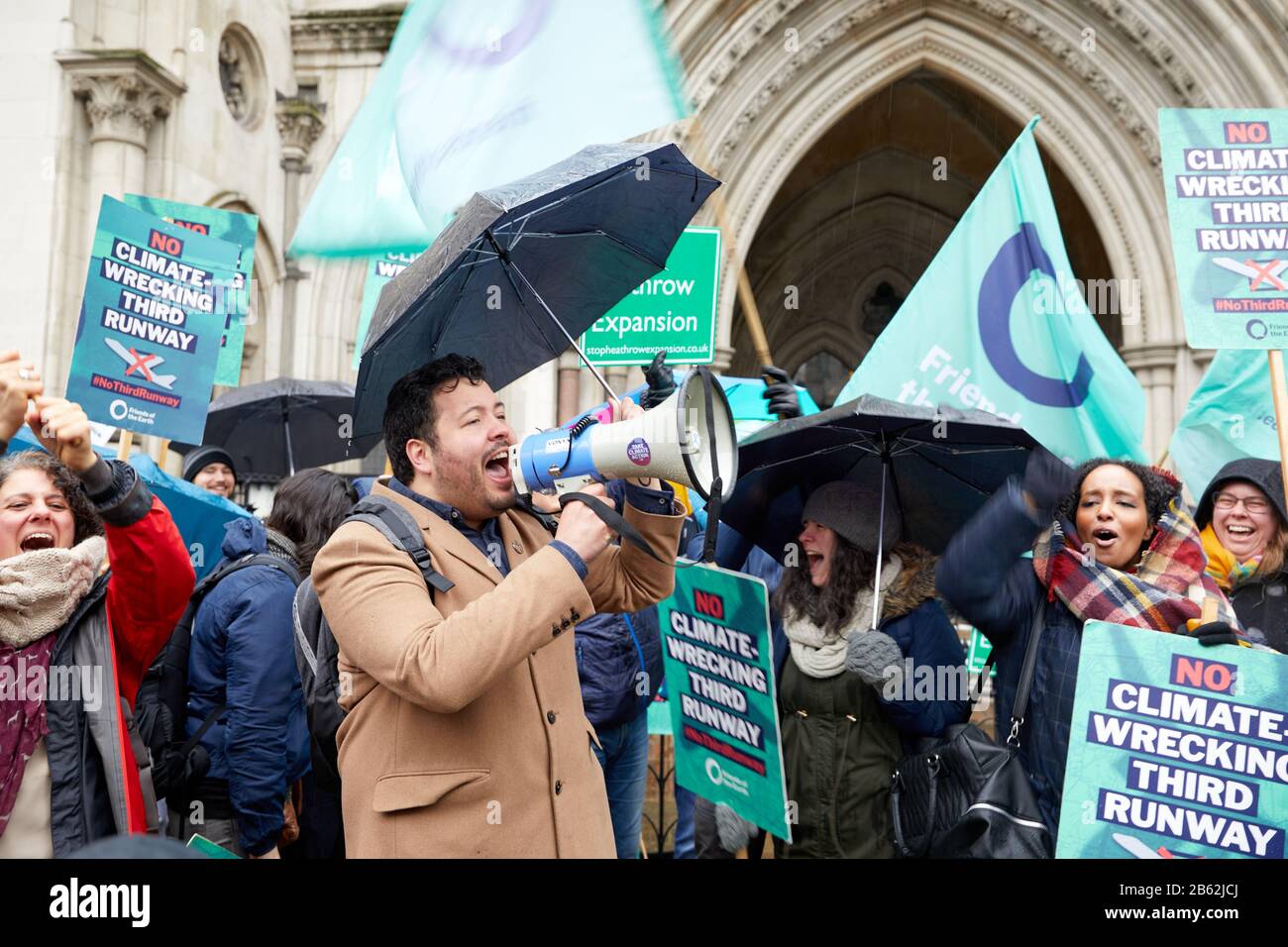 London, UK . - Feb 27, 2020: A campaigner outside the Royal Courts of Justice announces the success of their appeal against the government's decision to allow Heathrow expansion. Stock Photo