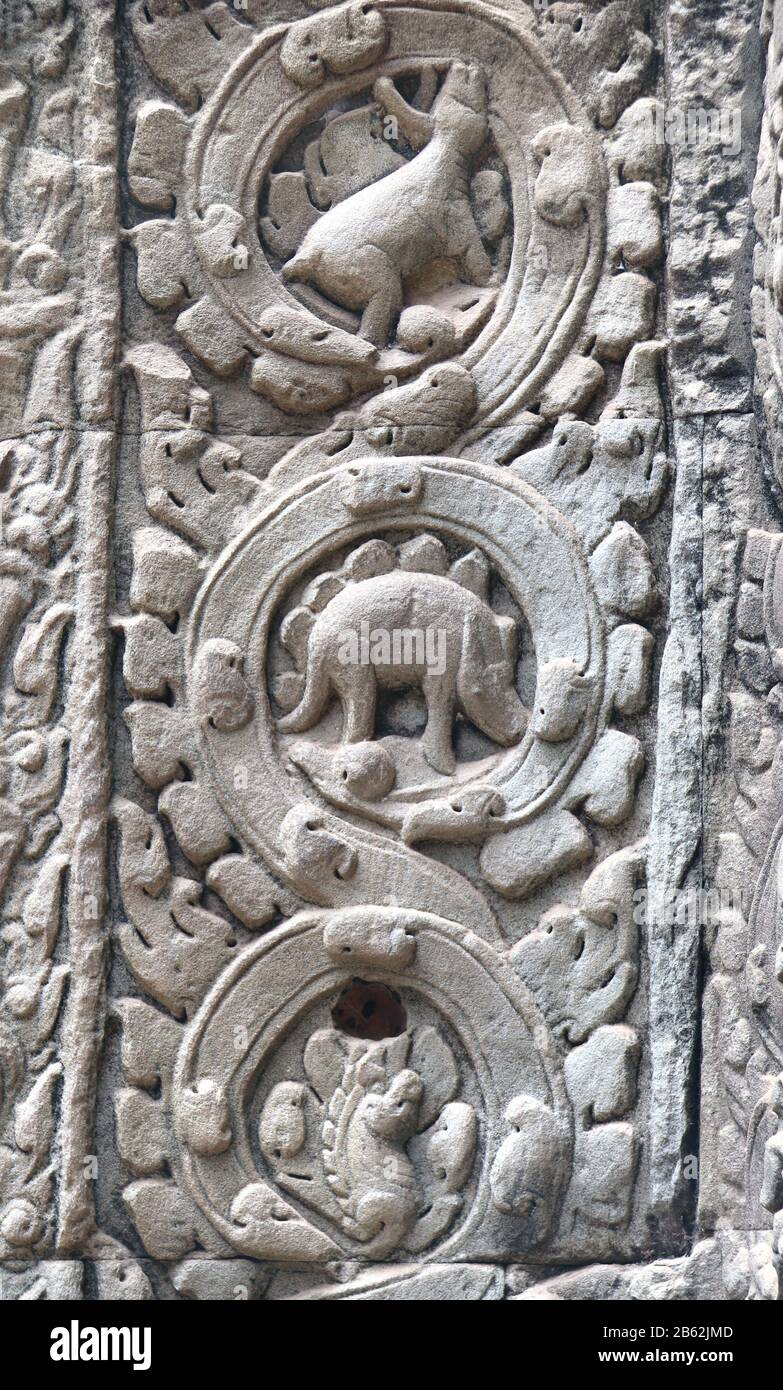 Mysterious bas-relief with dinosaur at the ancient Ta Prohm temple in famous Angkor Wat complex, khmer culture, Siem Reap, Cambodia. UNESCO world heri Stock Photo