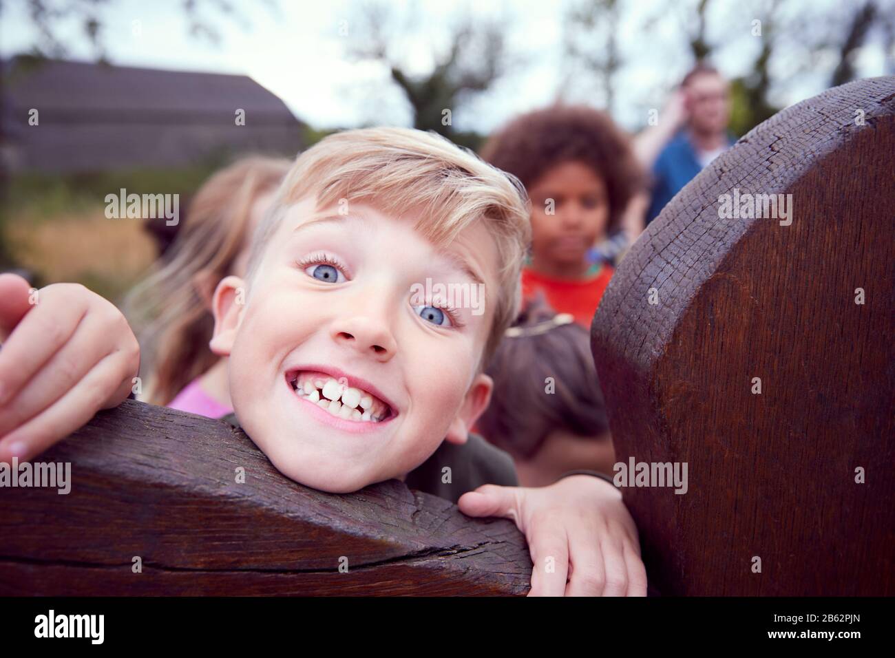 Portrait Of Children On Outdoor Activity Camping Trip Having Fun Playing Game Together Stock Photo