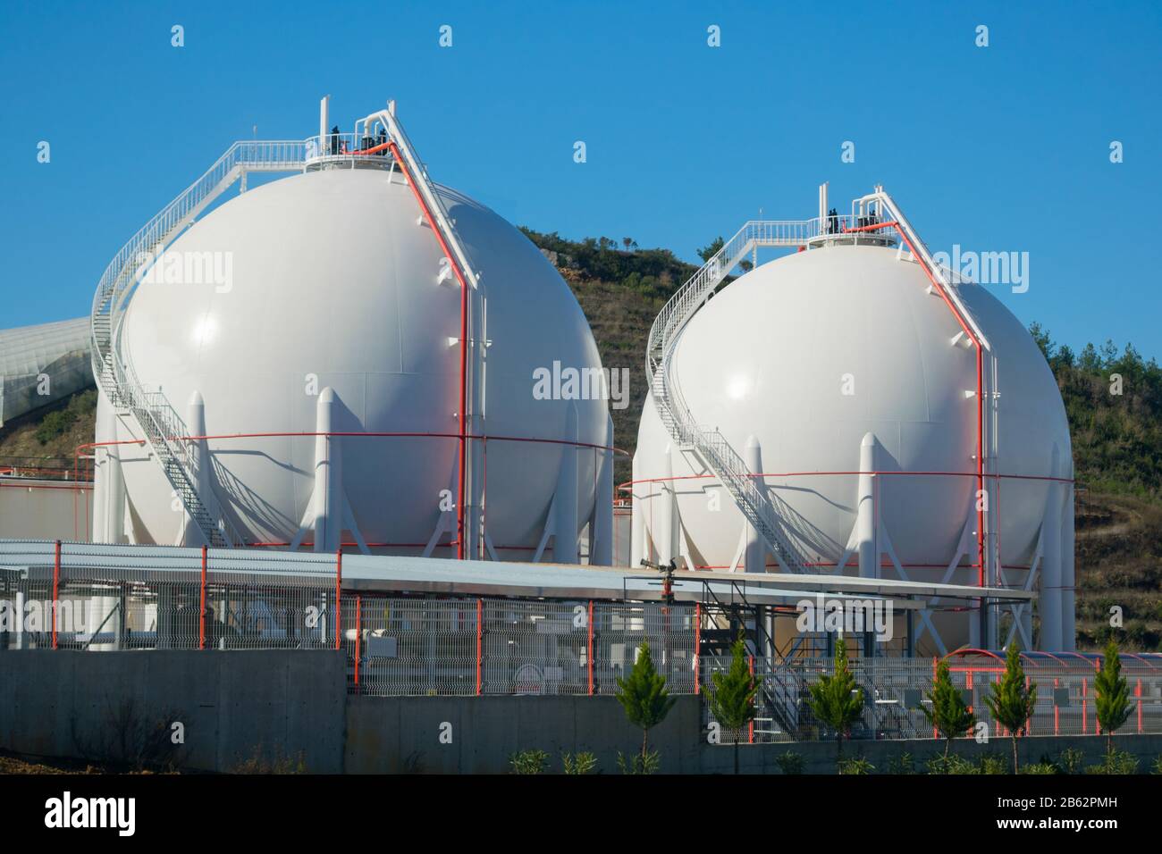 Two liquefied gas storage tanks. LNG/LPG storage plant. Stock Photo