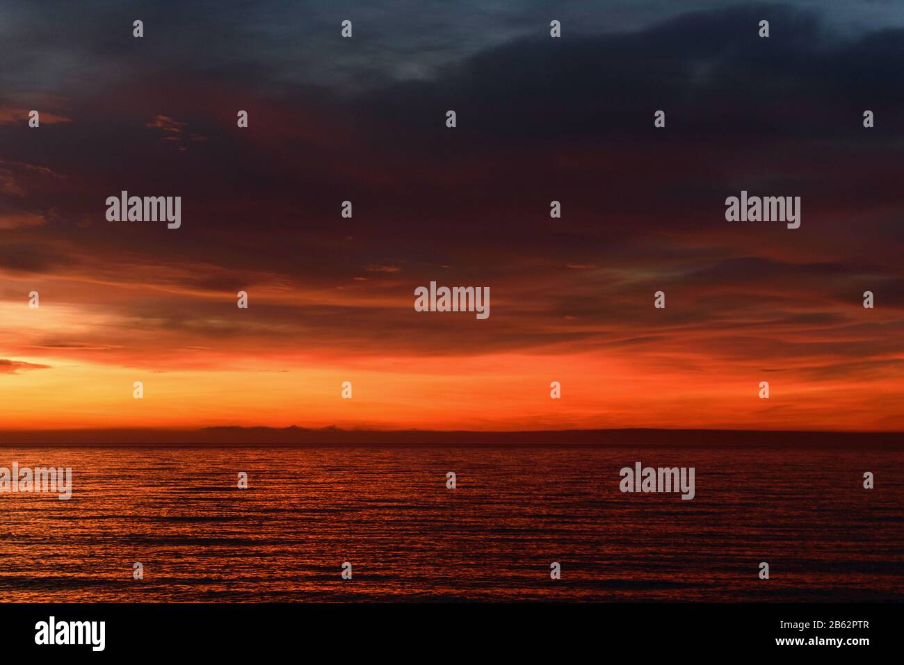 Orange sunrise over the sea. Dramatic sky clouds Stock Photo - Alamy