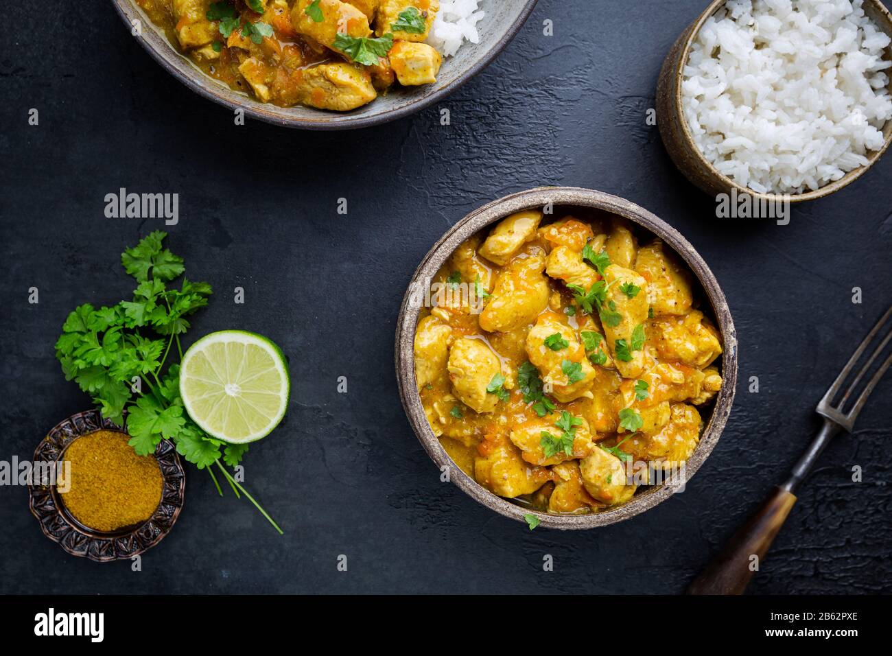 Spicy chicken cooked with curry sauce and rice, top view Stock Photo