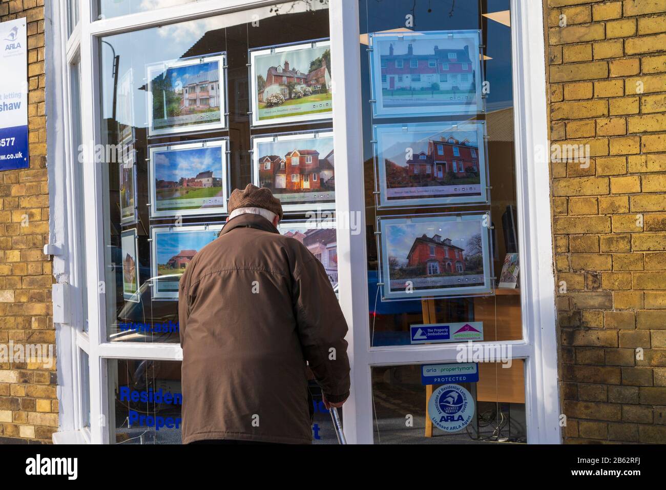 Elderly man looking at estate agent window, tenterden, kent, uk Stock