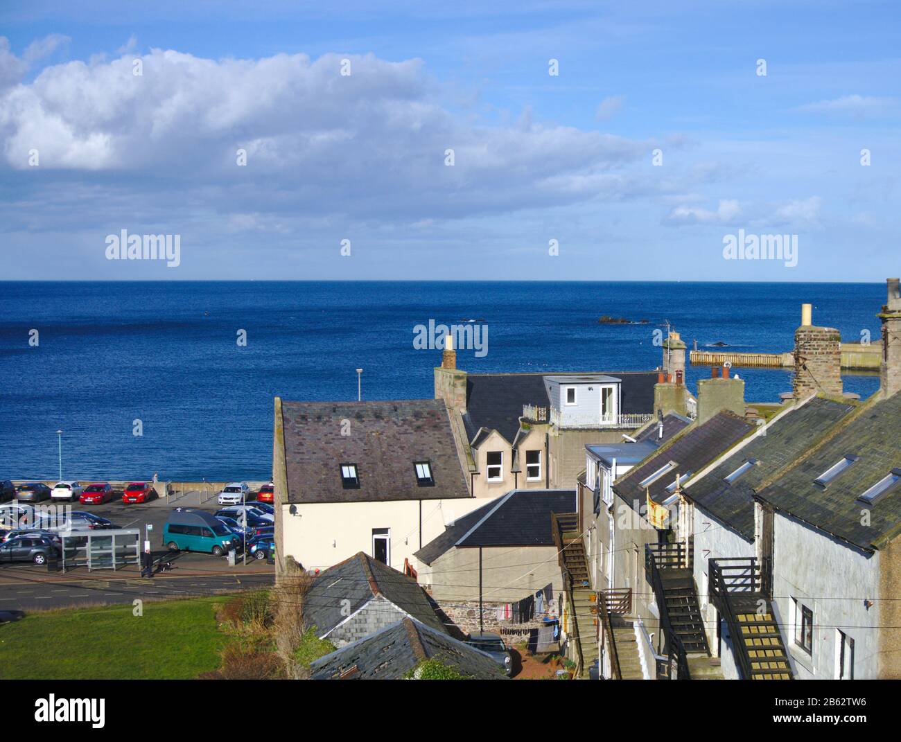 View across the bay to the North Sea over houses and car park from Eyemouth, Berwickshire, Scottish Borders, UK Stock Photo