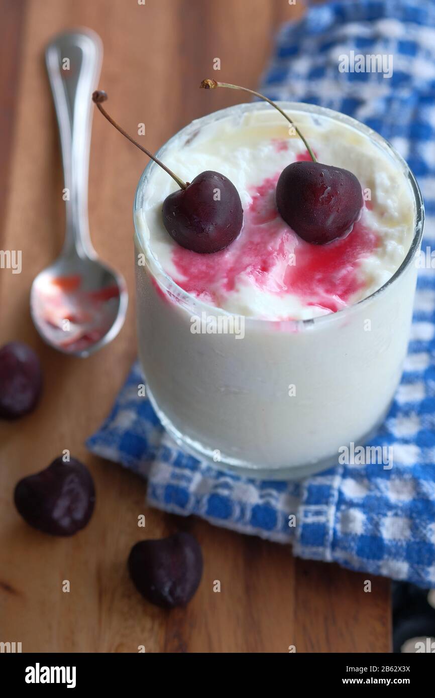 close up of cheery fruit on yogurt in a jar  Stock Photo