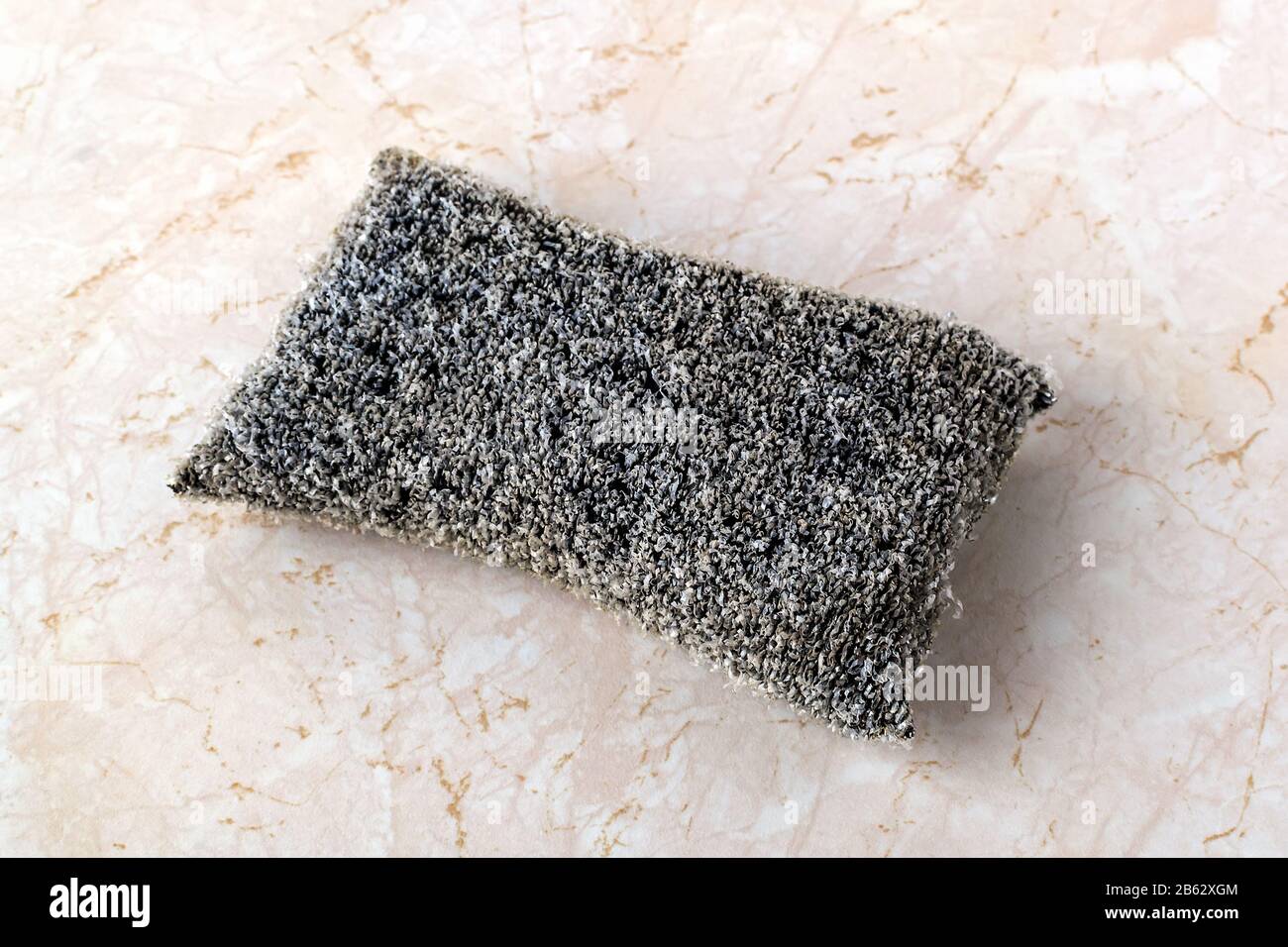https://c8.alamy.com/comp/2B62XGM/old-silver-foam-sponge-for-dishwashing-on-a-kithen-table-metallized-fiber-foam-sponge-for-dishes-and-housework-purity-and-household-chores-2B62XGM.jpg