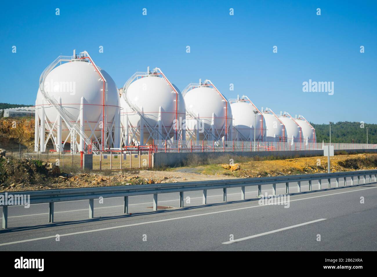 LNG storage tanks on a roadside. Sunny and clear view. Liquefied  petroleum gas (LPG) storage tanks. Gas plant. Stock Photo