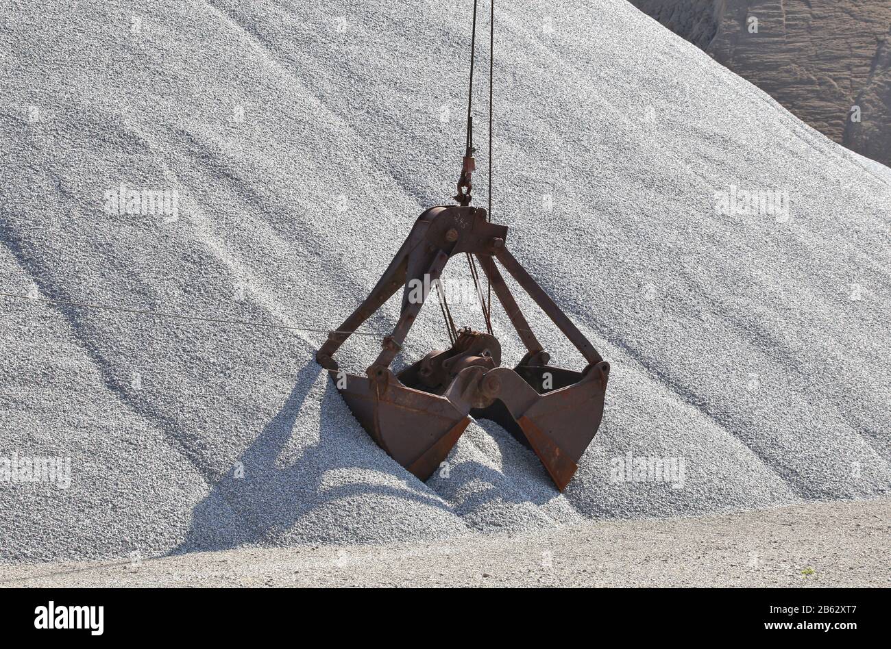 Clamshell Bucket at work in an open pit quarry Stock Photo