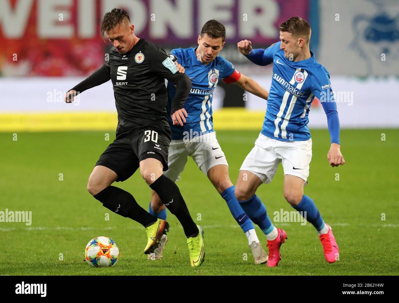 Rostock, Germany. 09th Mar, 2020. Football: 3rd league, 27th matchday,  Hansa Rostock - Eintracht Braunschweig in the Baltic Sea Stadium Brunswick  player Marvin Pourie (l-r), Hansa captain Julian Riedel and Hansa player