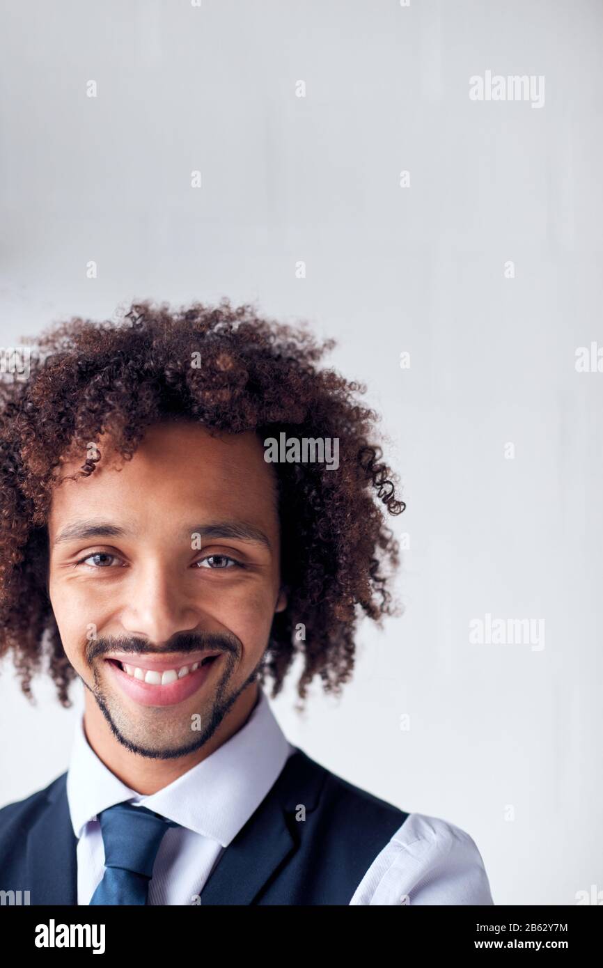 Portrait Of Confident Young Businessman Wearing Suit Standing Against ...