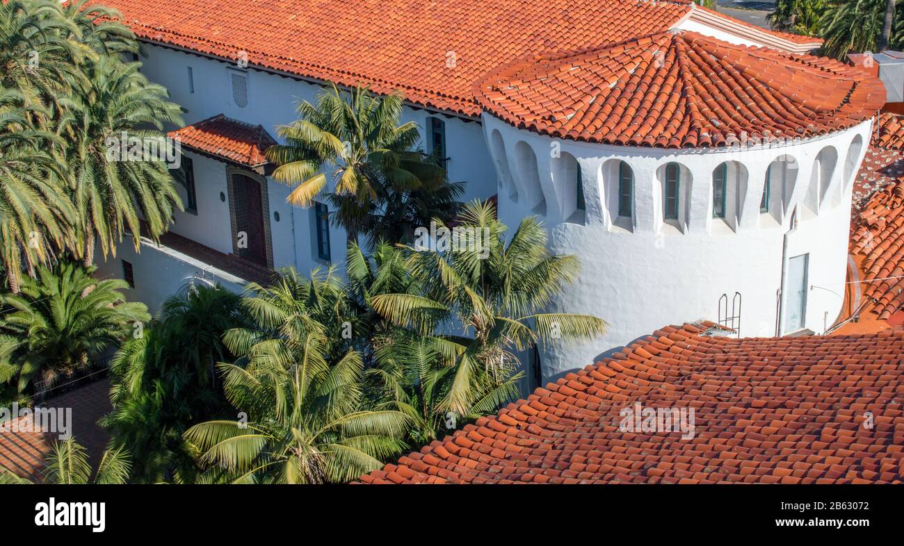 Red tile roof and Moorish architecture of the historic Santa Barbara County courthouse in California viewed from above amid lush trees Stock Photo