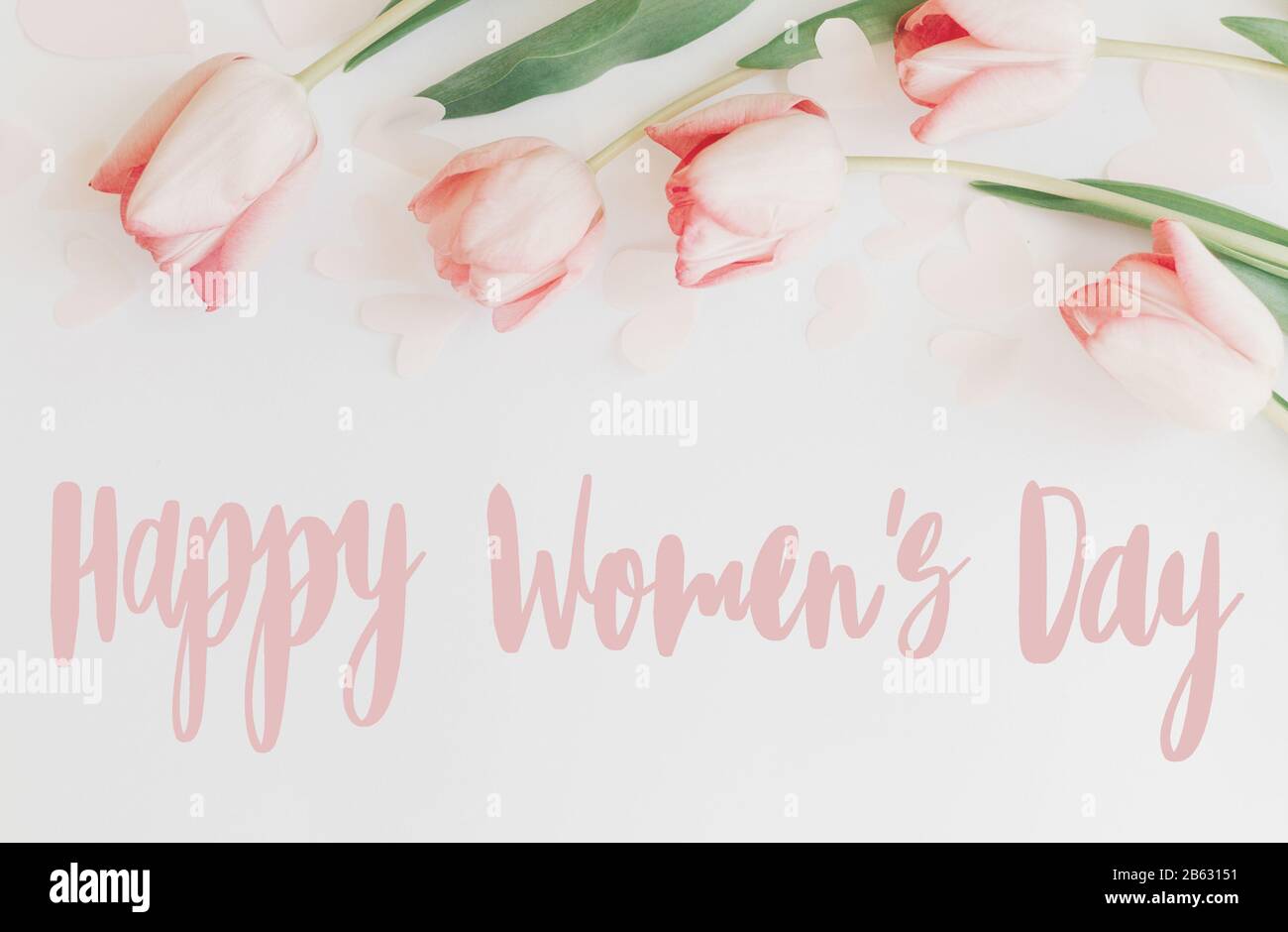 Happy Womens Day text on gift card in flower box near festive rose and gold  balloons. Greeting card for women on 8 March, International Women's Day  Stock Photo - Alamy