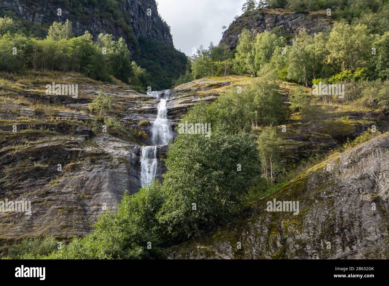 Waterfall falling, norwegian fjord Aurlandsfjord travel. Bright view on wild green mountains nature of Norway. Sunny day in Scandinavia. Stock Photo