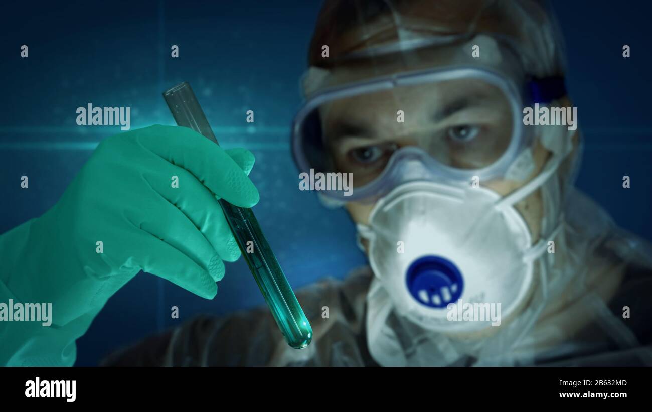 Scientist in mask and protection glass with test-tube in glove hand. Concept of laboratory, science research, biology, chemistry experiment, biotechno Stock Photo