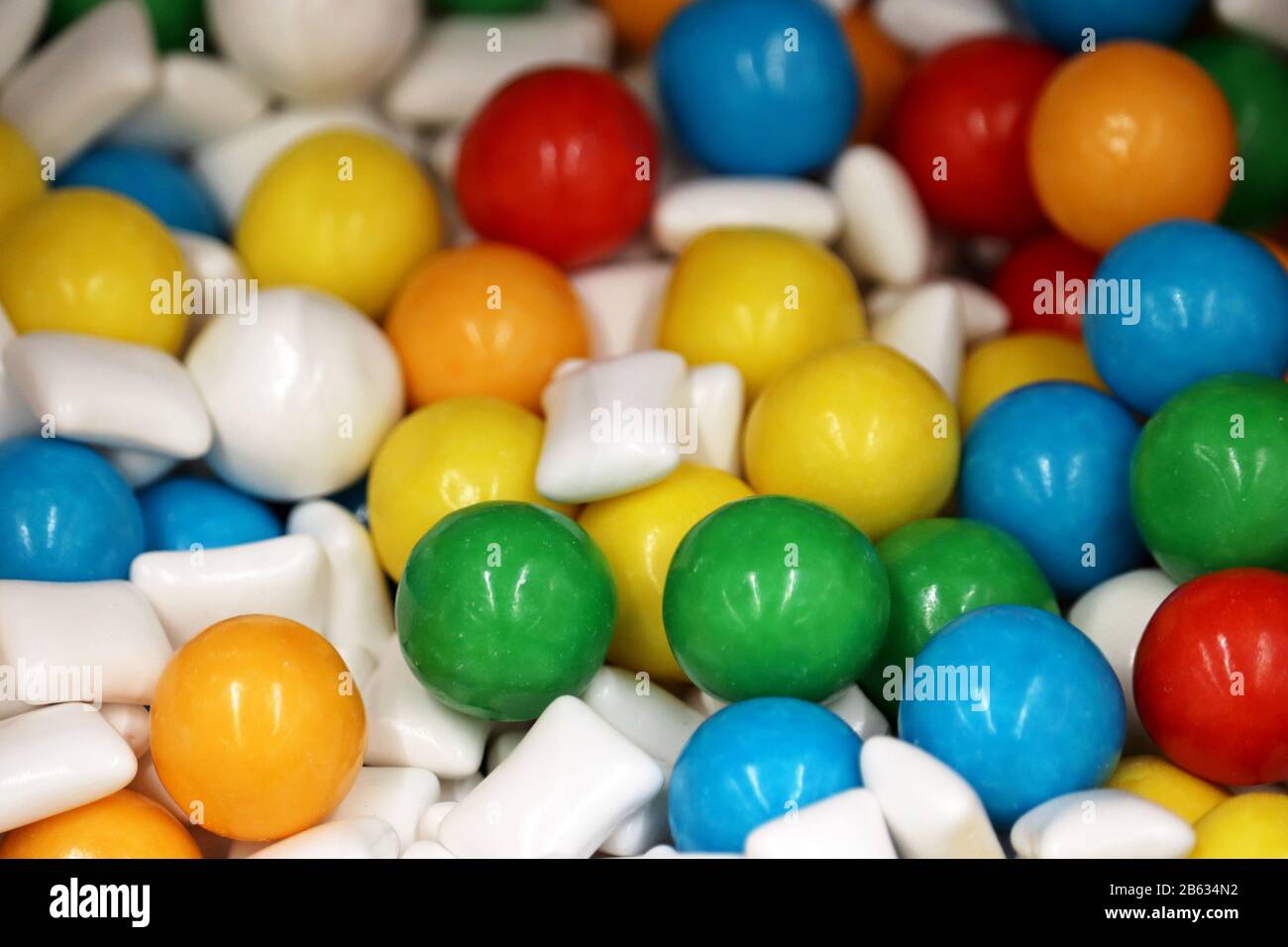 Chewing gumballs, colorful jelly candy. Green, yellow, blue and white gummy marmalade for background Stock Photo