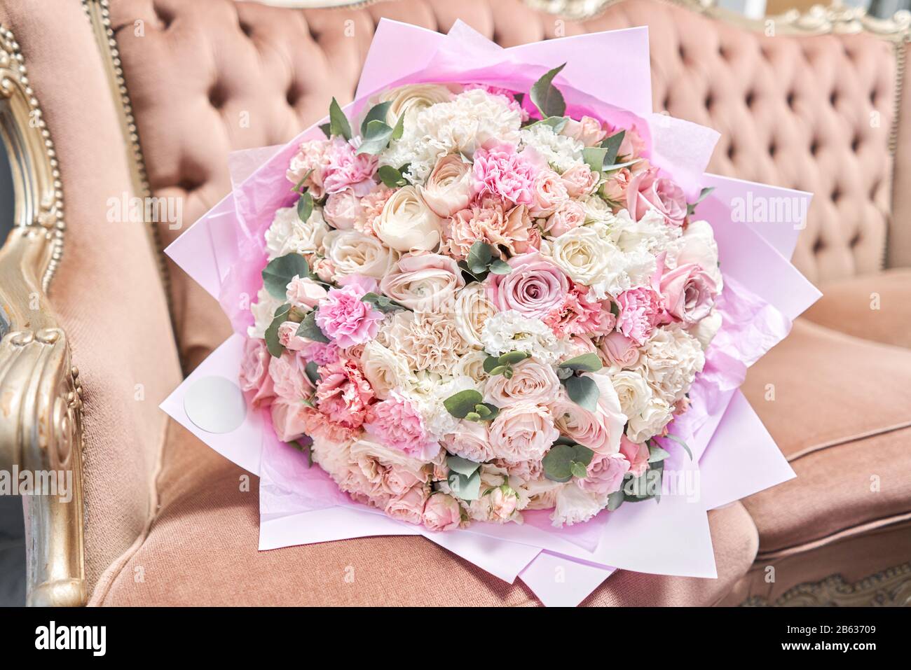 Beautiful bouquet of mixed flowers on a vintage sofa. the work of the