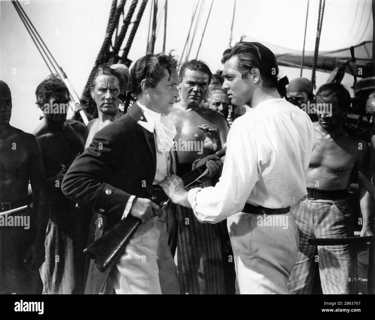FRANCHOT TONE as Midshipman Roger Byam and CLARK GABLE as Fletcher