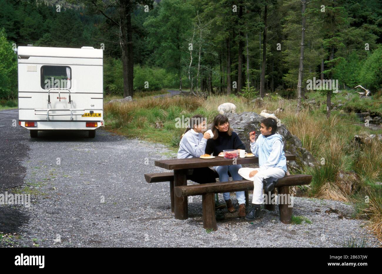 Mother and two daughters out with their old motorhome,  Gougane Barra, Macroom in County Cork, Ireland. Stock Photo