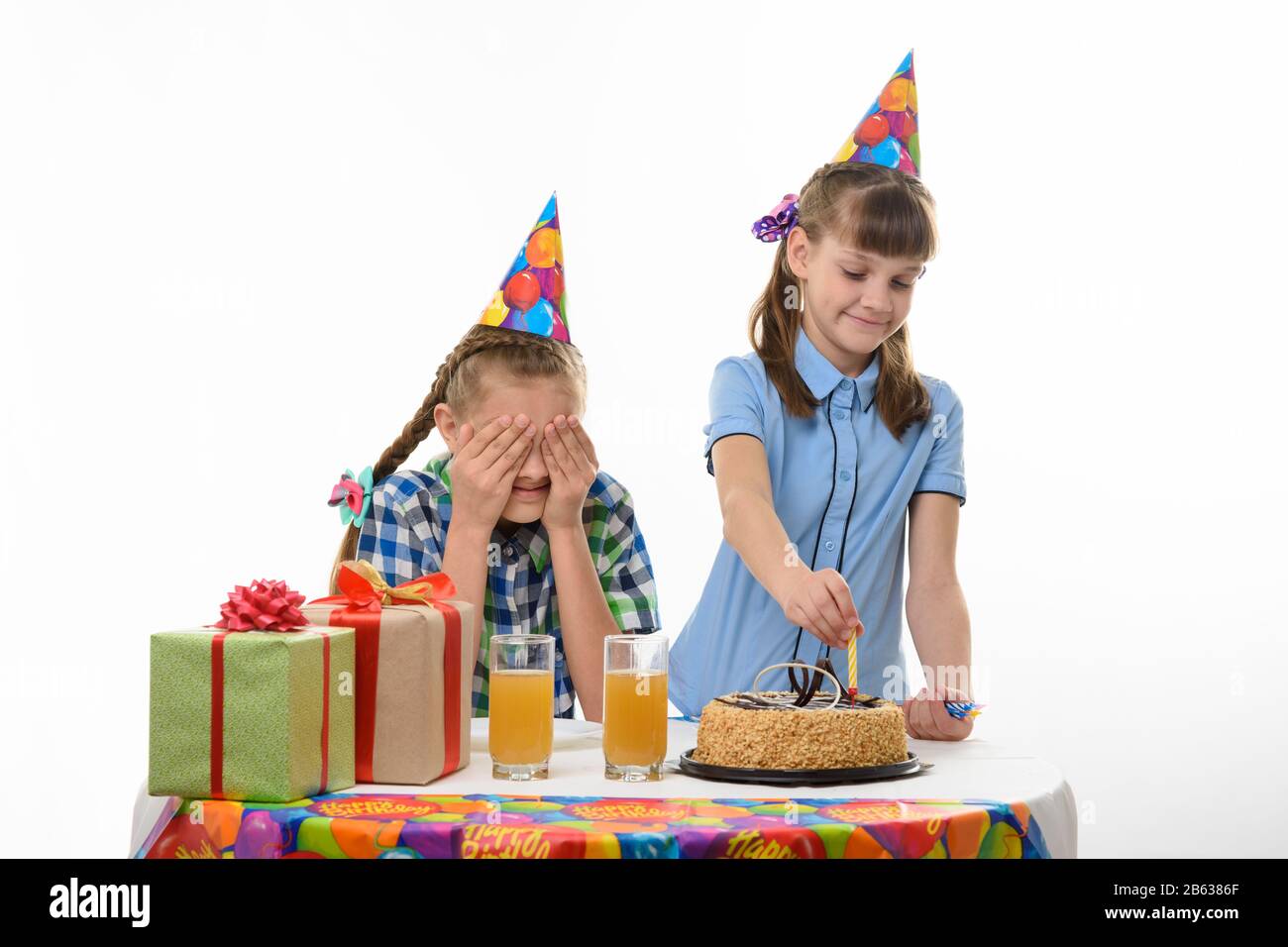 Girl puts candles on a birthday cake Stock Photo Alamy