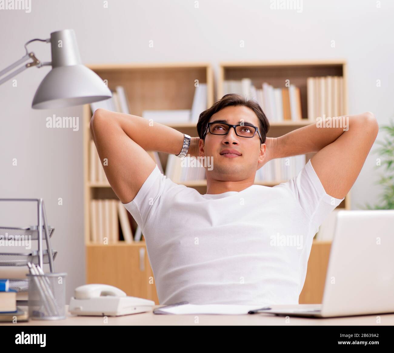 The young man working in the office Stock Photo - Alamy