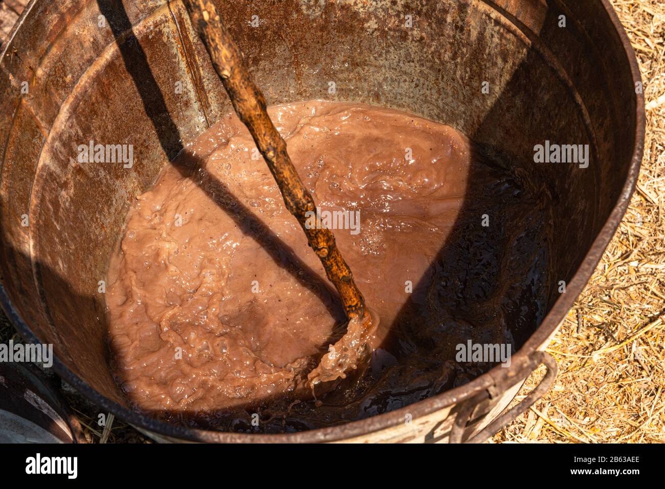 Mixing of caustic potash with olive oil and water to make a chemical