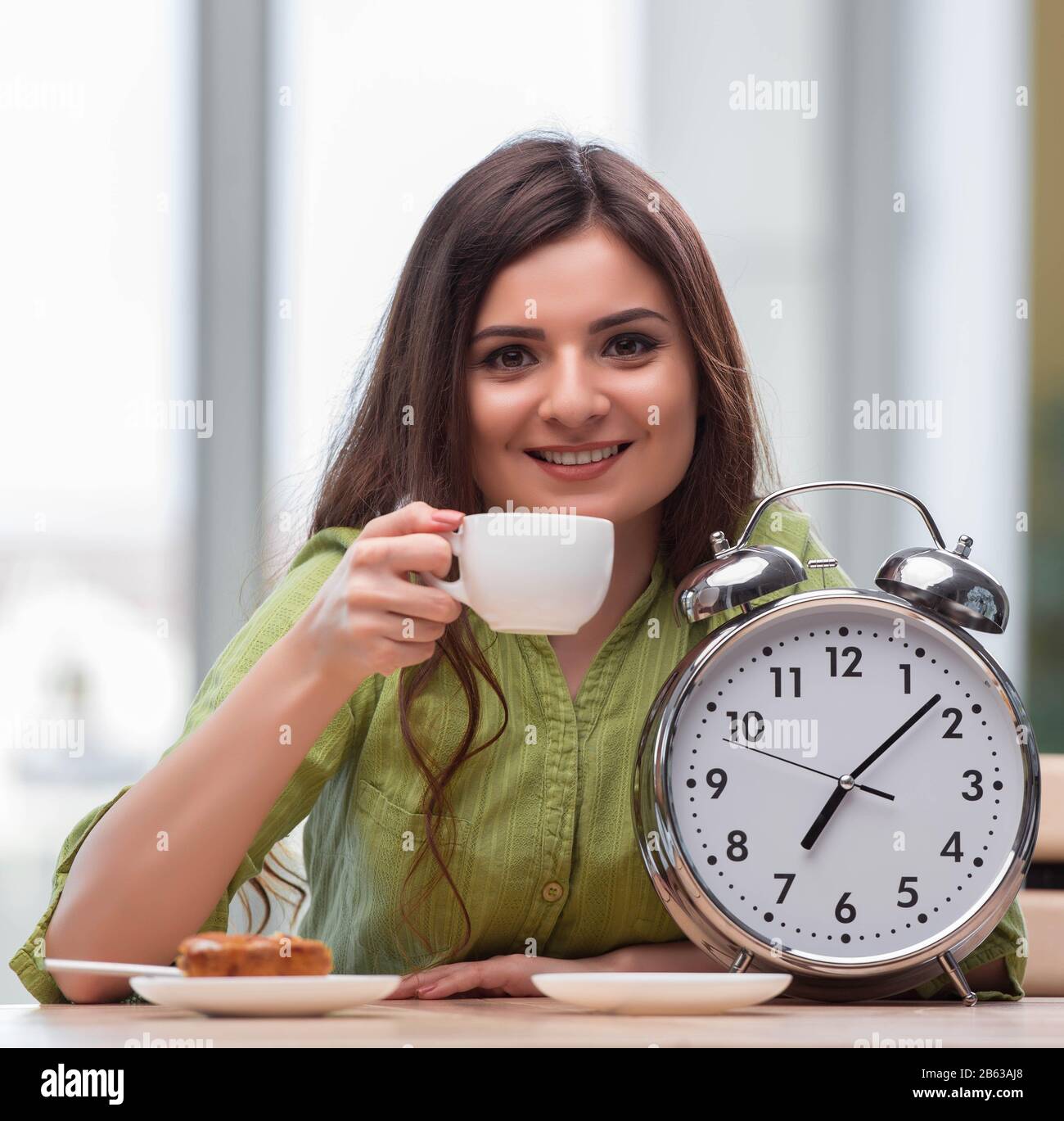 The student with gian alarm clock preparing for exams Stock Photo Alamy