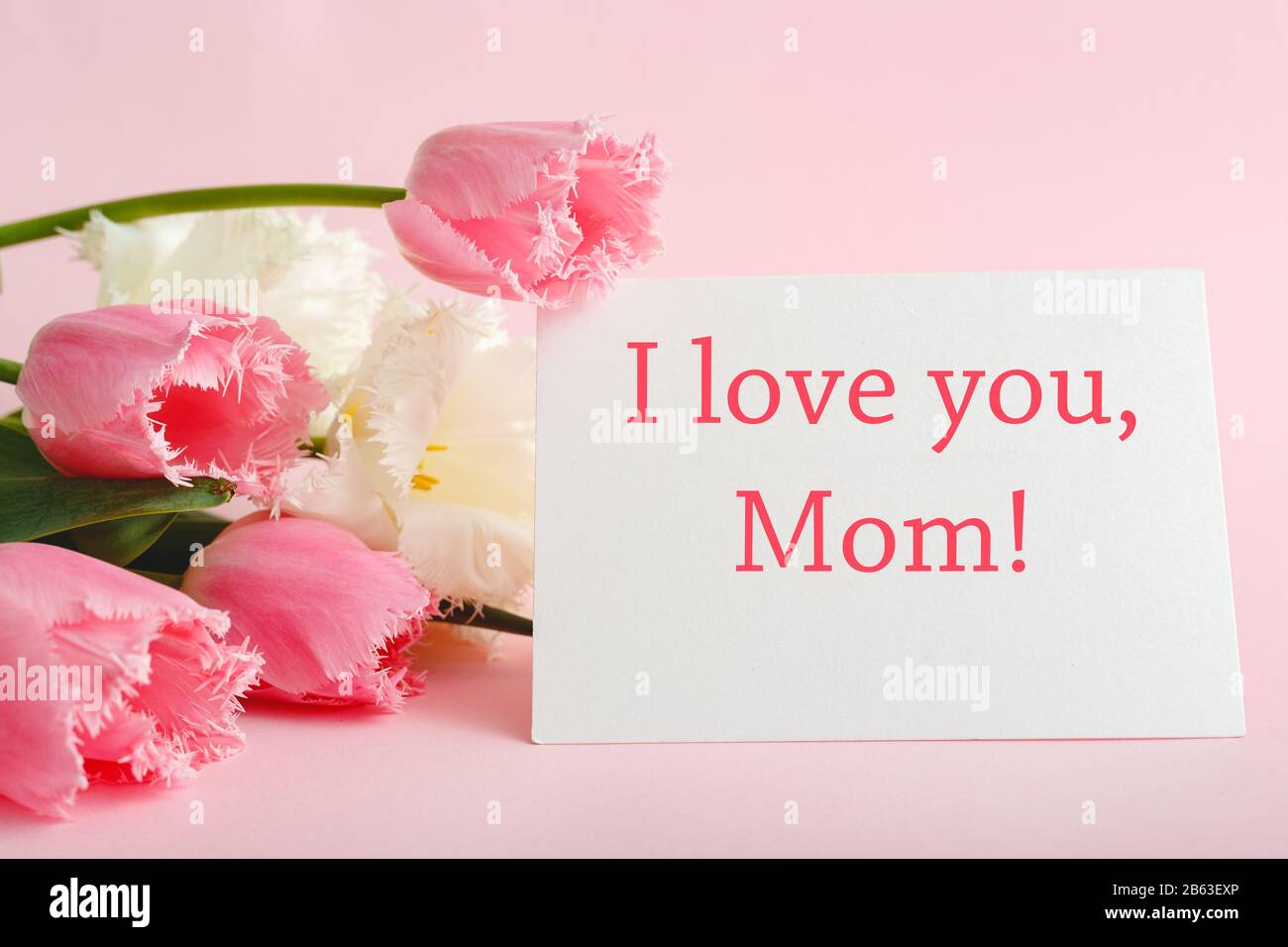I love you Mom text on gift card in flower bouquet on pink ...