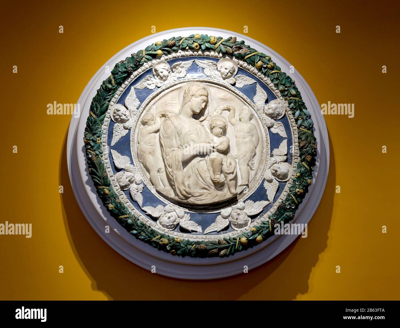 Virgin and Child. Marble medaillon with ceramic frame. 16th Cent. Della Robbia workshop and marble by Andrea Sansovino. Museum, Lisbon. Stock Photo
