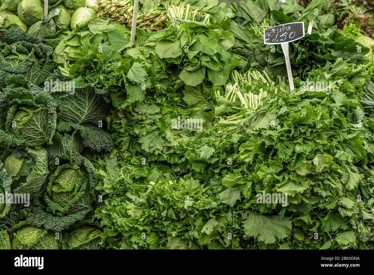 Variety of green vegetables on display with prices on a market stall at the fruit and vegetable market in Cascais Portugal Stock Photo